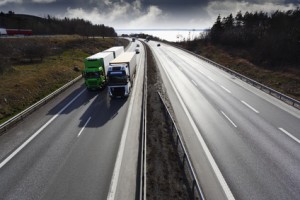 two trucks on straight freeway, elevated view